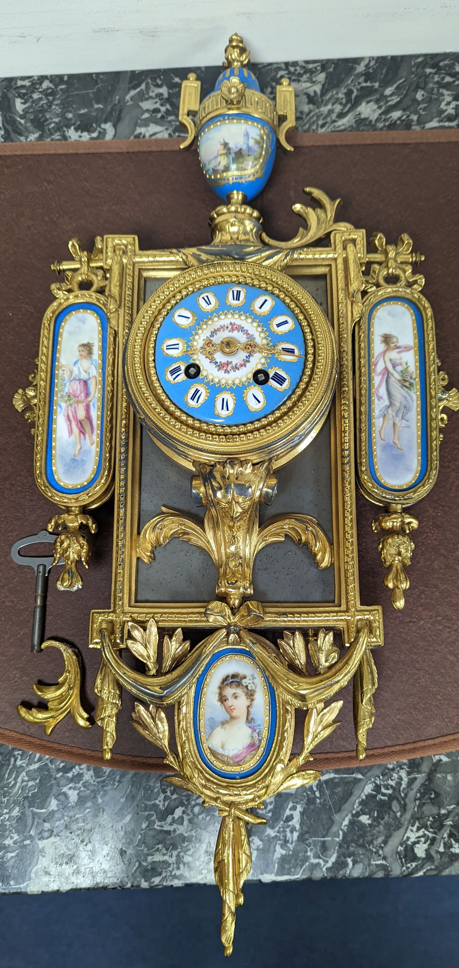 An early 20th century gilt metal and Sevres style porcelain mounted wall clock 58cm